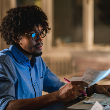 Young man using laptop at night.