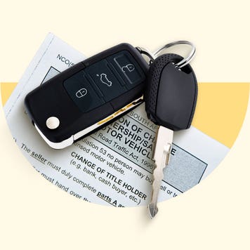 A car key and key fob on top of a sheet of paper.