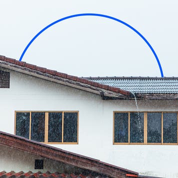 image of home in the rain with water pouring off roof