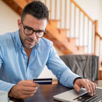 Modern businessman using laptop and credit card