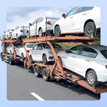 A truck hauling a number of white passenger vehicles in two stacks. The image is imposed over an illustrated blue background.