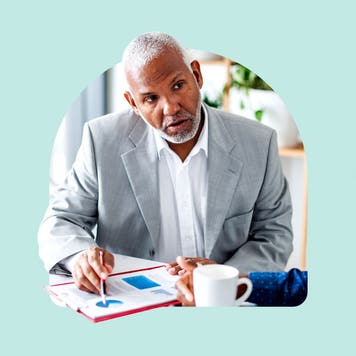 A financial planner references a graph.