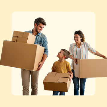 Family of three smiling and carrying boxes