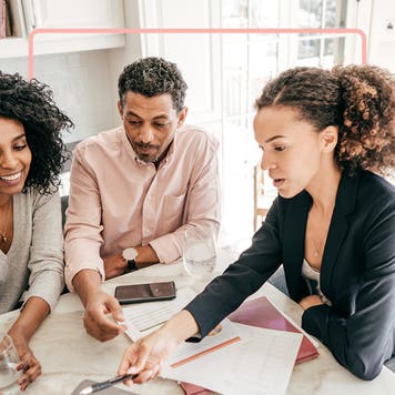 Small business owners looking at application