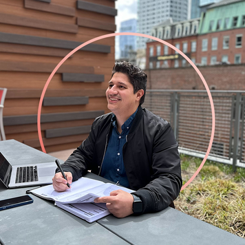 A photo of the author of the article near a computer and book