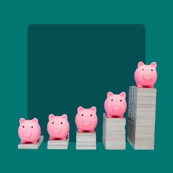 piggy banks on top of money stacks