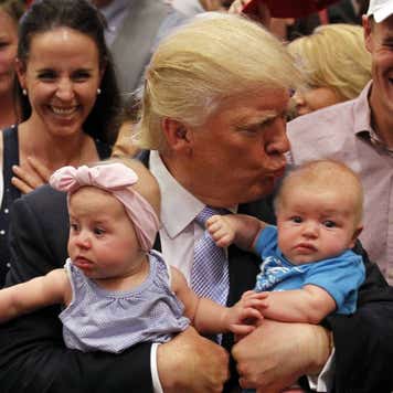 Donald Trump holding two babies.