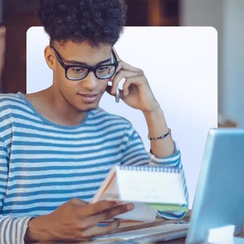 homeowner in striped sweater looking over financial paperwork
