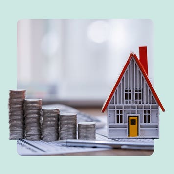 A house next to piles of coins.
