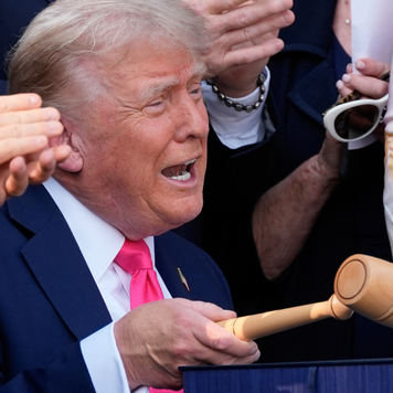 President Donald Trump bangs a gavel after signing the "One, Big Beautiful Bill" Act into law during an Independence Day military family picnic on the South Lawn of the White House on July 04, 2025.