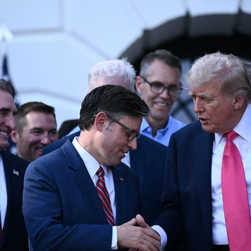 US President Donald Trump shakes hands with House Speaker Mike Johnson after signing the "Big Beautiful Bill Act" at the White House in Washington, DC, on July 4, 2025.