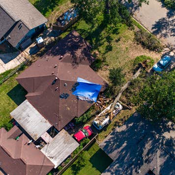 Aerial view of tree falling on house after storm in Houston