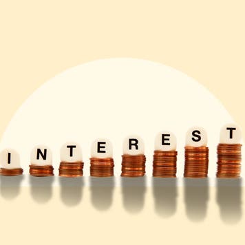 a stack of coins with letters on top of each one spelling out interest