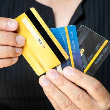 Man holding several credit cards and he is choosing a credit card to pay and spend Payment for goods via credit card
