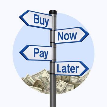 A signpost that reads "buy now pay later" with a pile of money behind it.