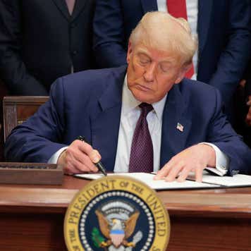 Donald Trump signs an executive order.