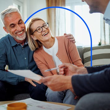 Older couple sitting in their living room with their financial advisor