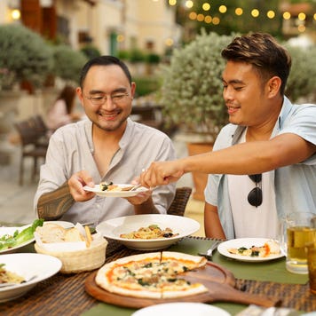 Happy men couple celebrating anniversary together outdoor dining during vacation, Outdoor dining, gay couple enjoy eating at the outdoor restaurants
