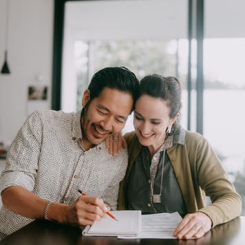 Cheerful couple planning a business budget