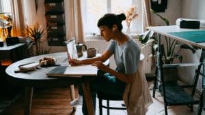 Young woman working on laptop at home.