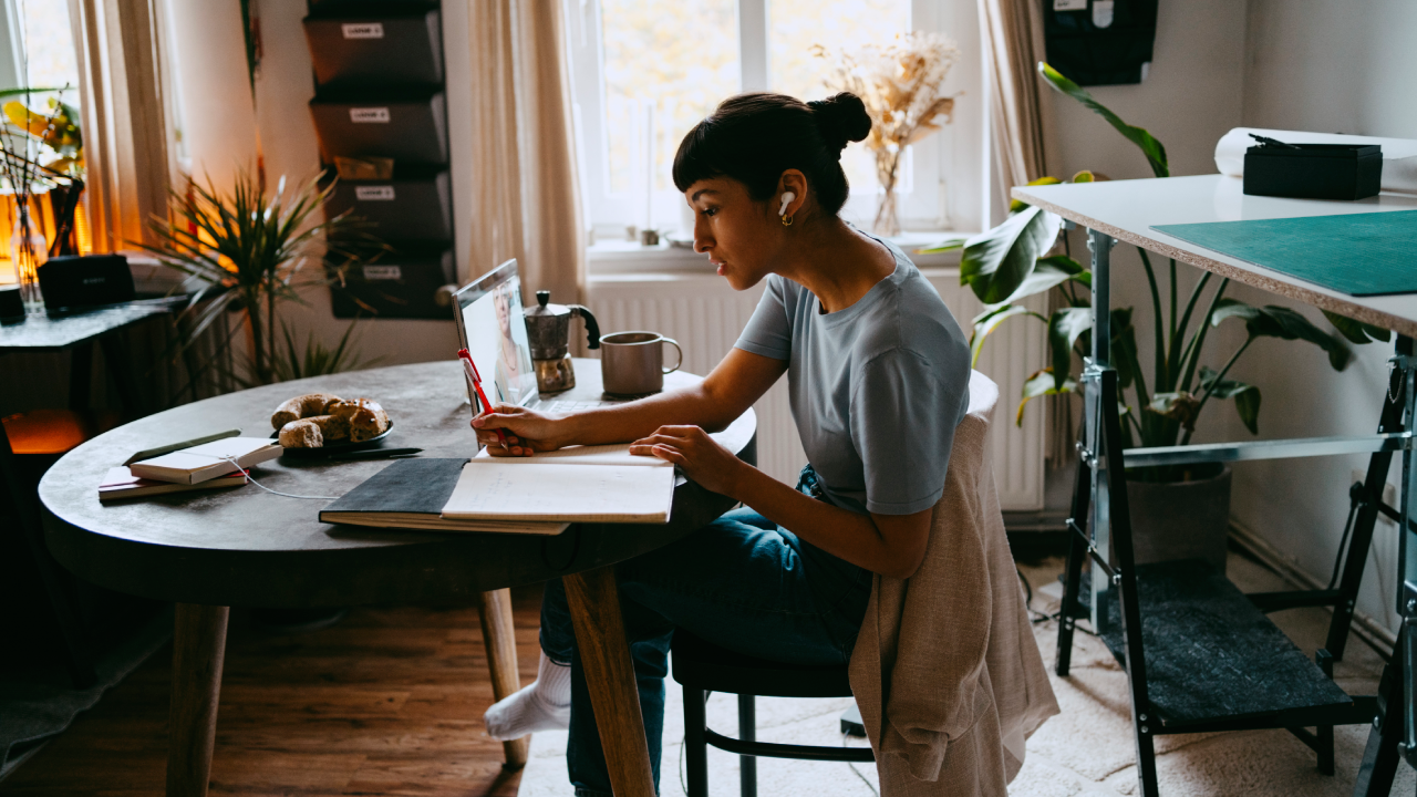 Young woman working on laptop at home.