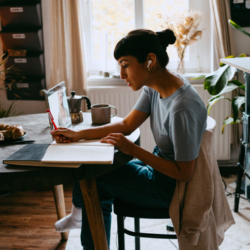 Young woman working on laptop at home.