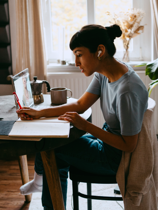 Young woman working on laptop at home.
