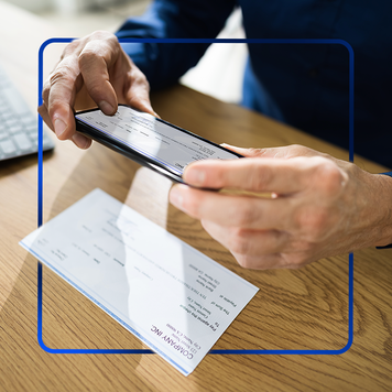 Photo of person taking photo of check with design element included