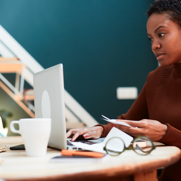 Woman at her laptop calculating finances.