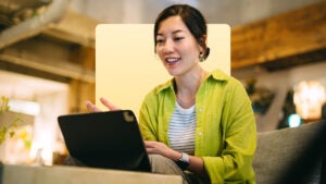 design image of a woman on her laptop smiling
