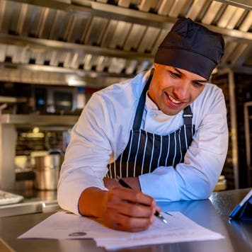 Chef looking over a business plan in a restaurant
