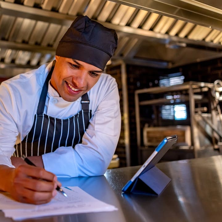 Chef looking over a business plan in a restaurant