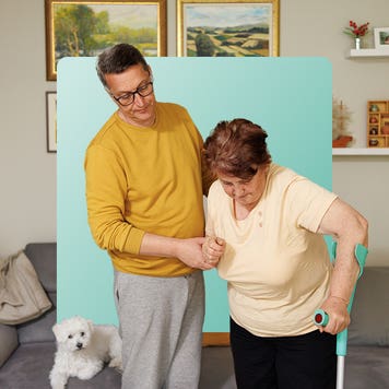 Image of a man supporting a woman who is using a forearm crutch.