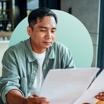 man reading paperwork side by side