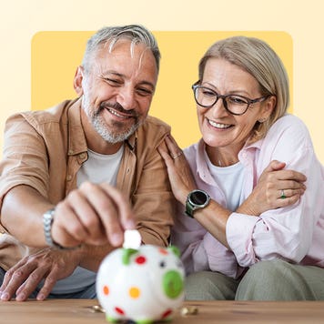 And older couple place a coin in a piggy bank and smile.