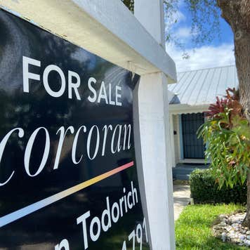 A close-up on a home for sale sign
