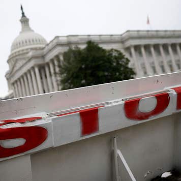 The US Capitol building is seen behind a barricade amidst the government shutdown