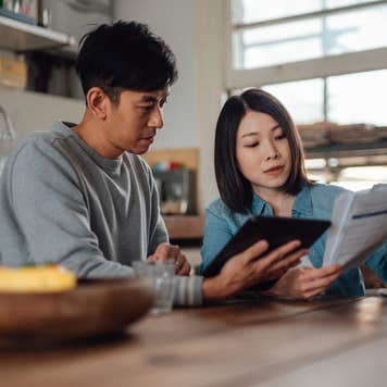 Couple looking over finances in their kitchen