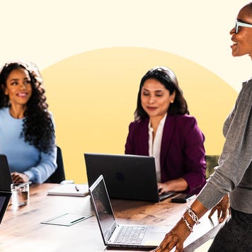 Working women gathered around a table at an office