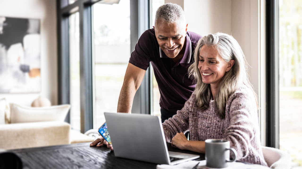 Older couple using a laptop at home.