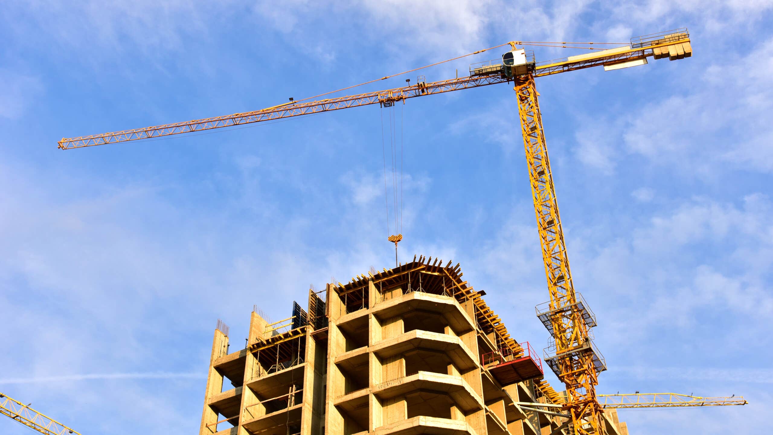 Construction crane stands above building in progress