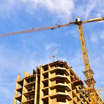 Construction crane stands above building in progress