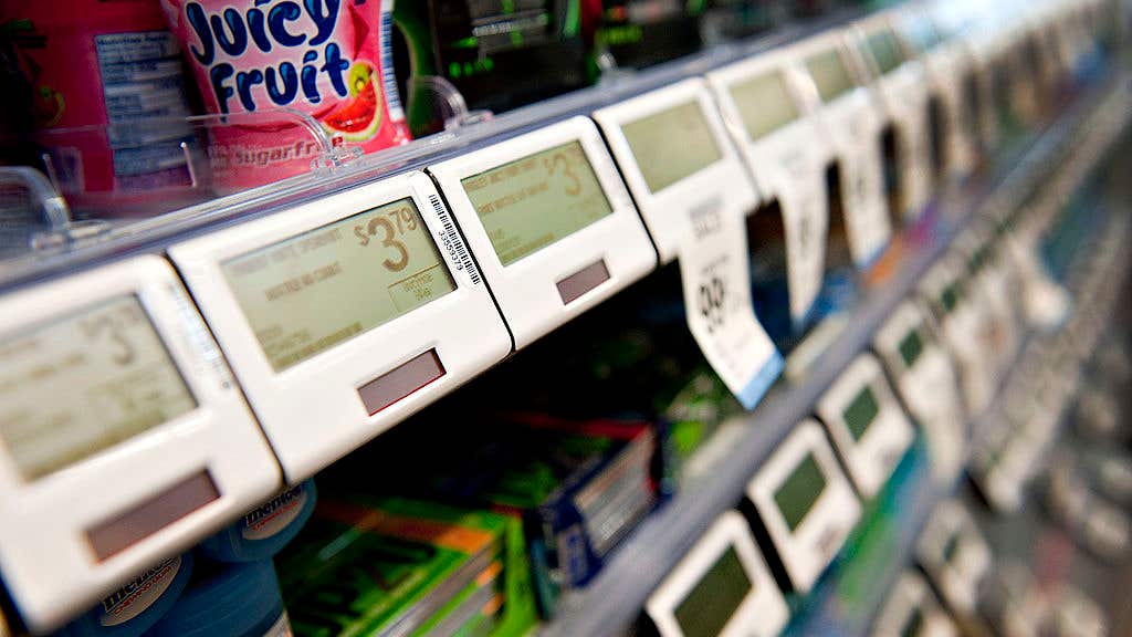 Digital price tags sit below candy items displayed for sale at a Walgreen Co. store in Oak Park, Illinois, U.S.
