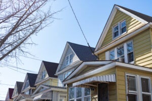 View of the tops of gabled homes in a row