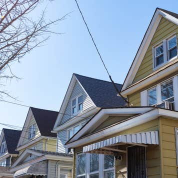 View of the tops of gabled homes in a row