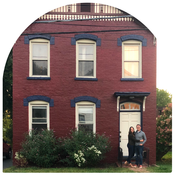 Ali and Josh Lupo in front of one of their first homes.