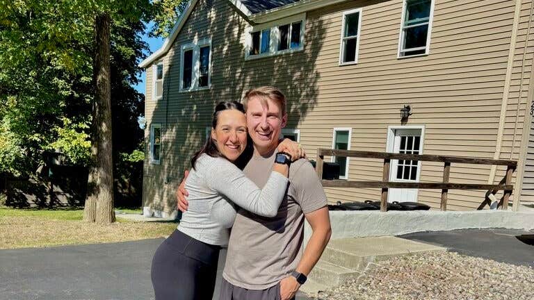 Ali and Josh Lupo in front of one of their homes.