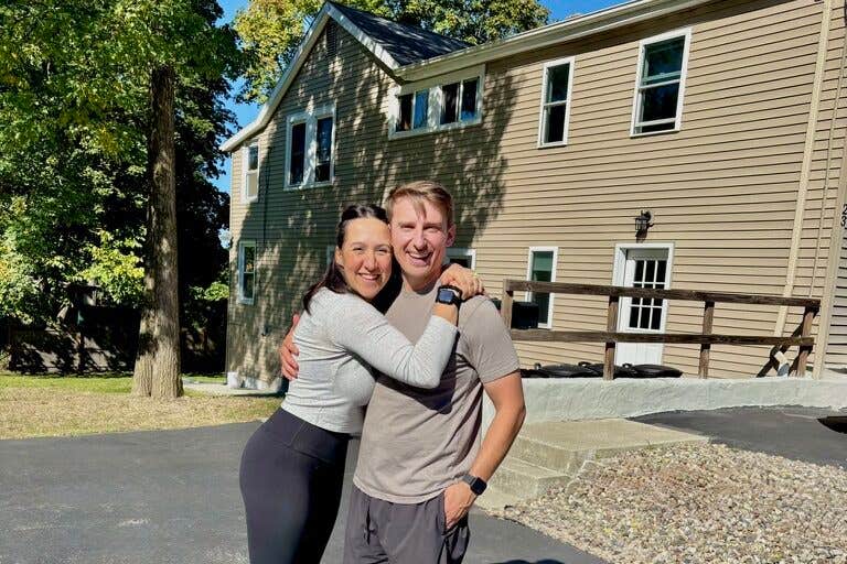 Ali and Josh Lupo in front of one of their homes.
