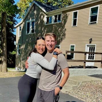Ali and Josh Lupo in front of one of their homes.