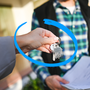 A real estate agent hands the keys to a new homebuyer.
